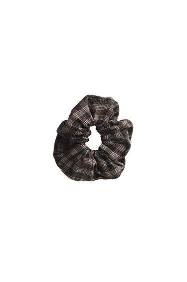 Front view of a dark checked fabric scrunchie.