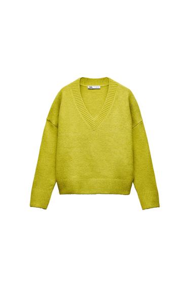 Yellow-green knitted jumper with a V-neck and long sleeves on a white background. Inner label with the text ZARA.