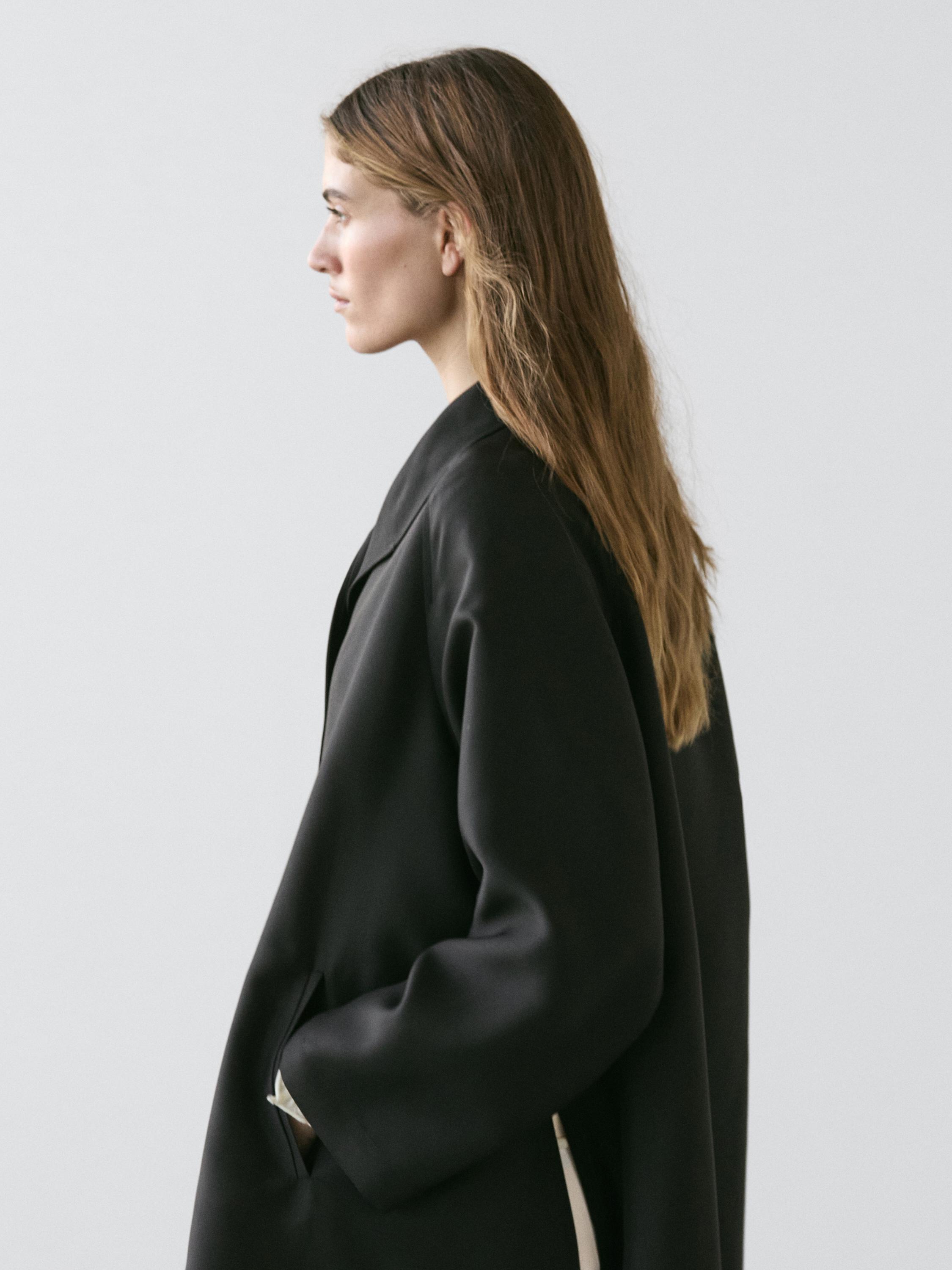 Flowing voluminous cape with button details