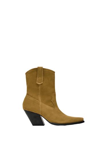 Side view of a brown boot with a high heel and pointed toe.