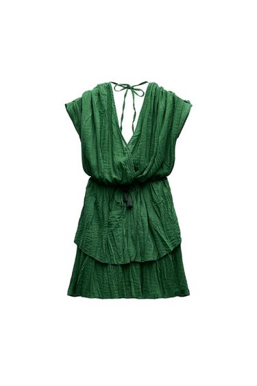 Front view of a green dress with a V-neck and adjustable waist.