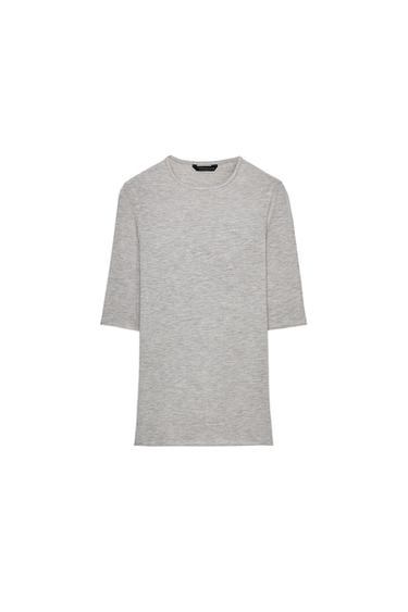 Front view of a beige marl, fitted T-shirt with a round neck, three-quarter sleeves, and a straight hem.