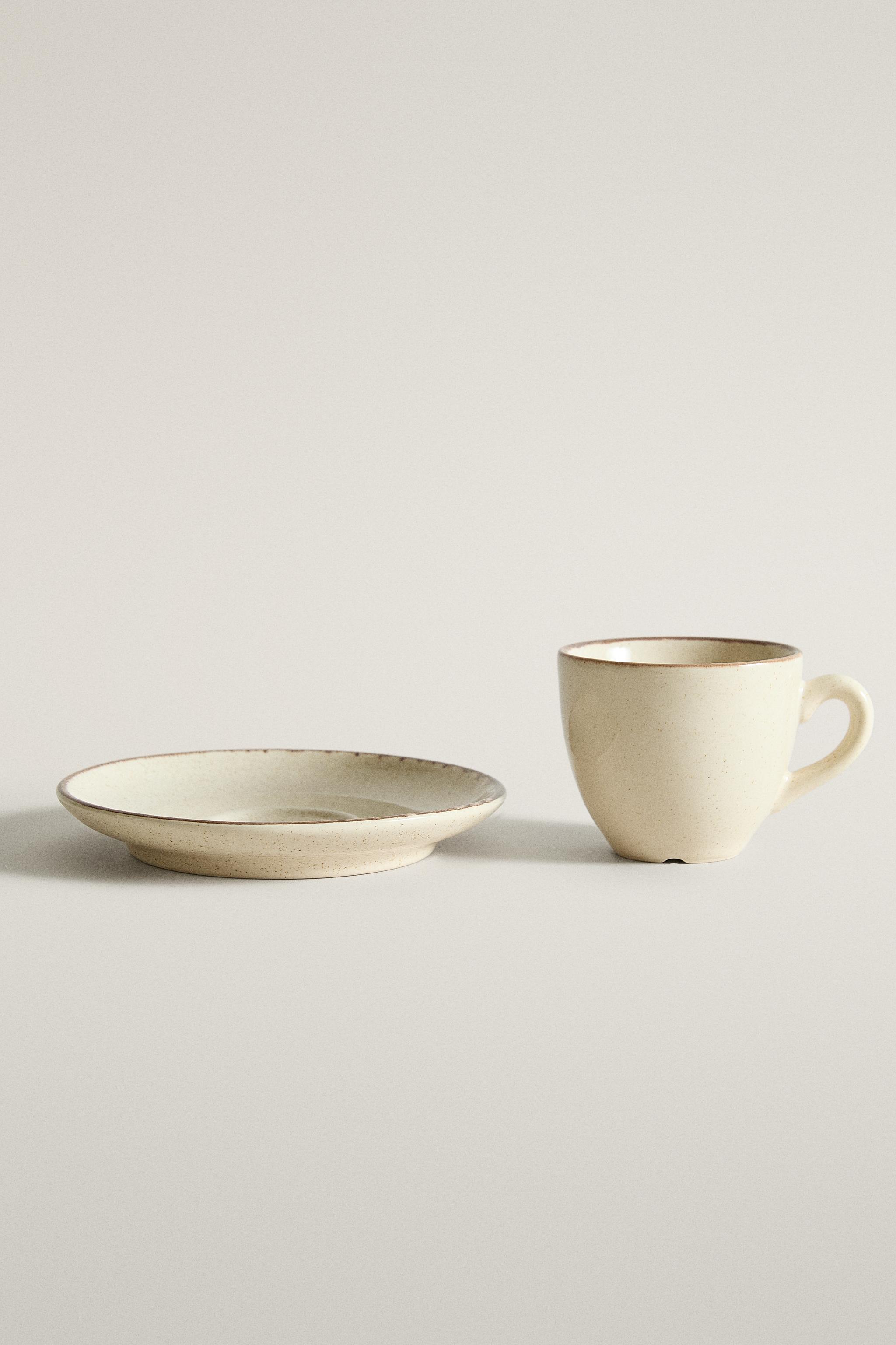 STONEWARE COFFEE CUP AND SAUCER WITH DISTRESSED RIM