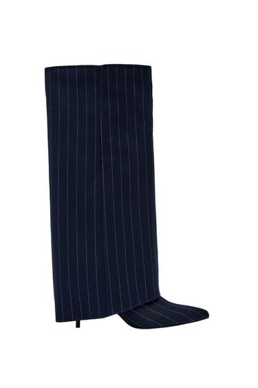High boot with a thin heel in navy blue with a design of white vertical stripes on a white background.