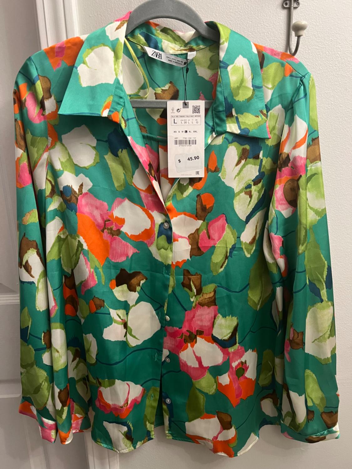 Front view of a multicolor floral print shirt with a classic collar and front button closure.