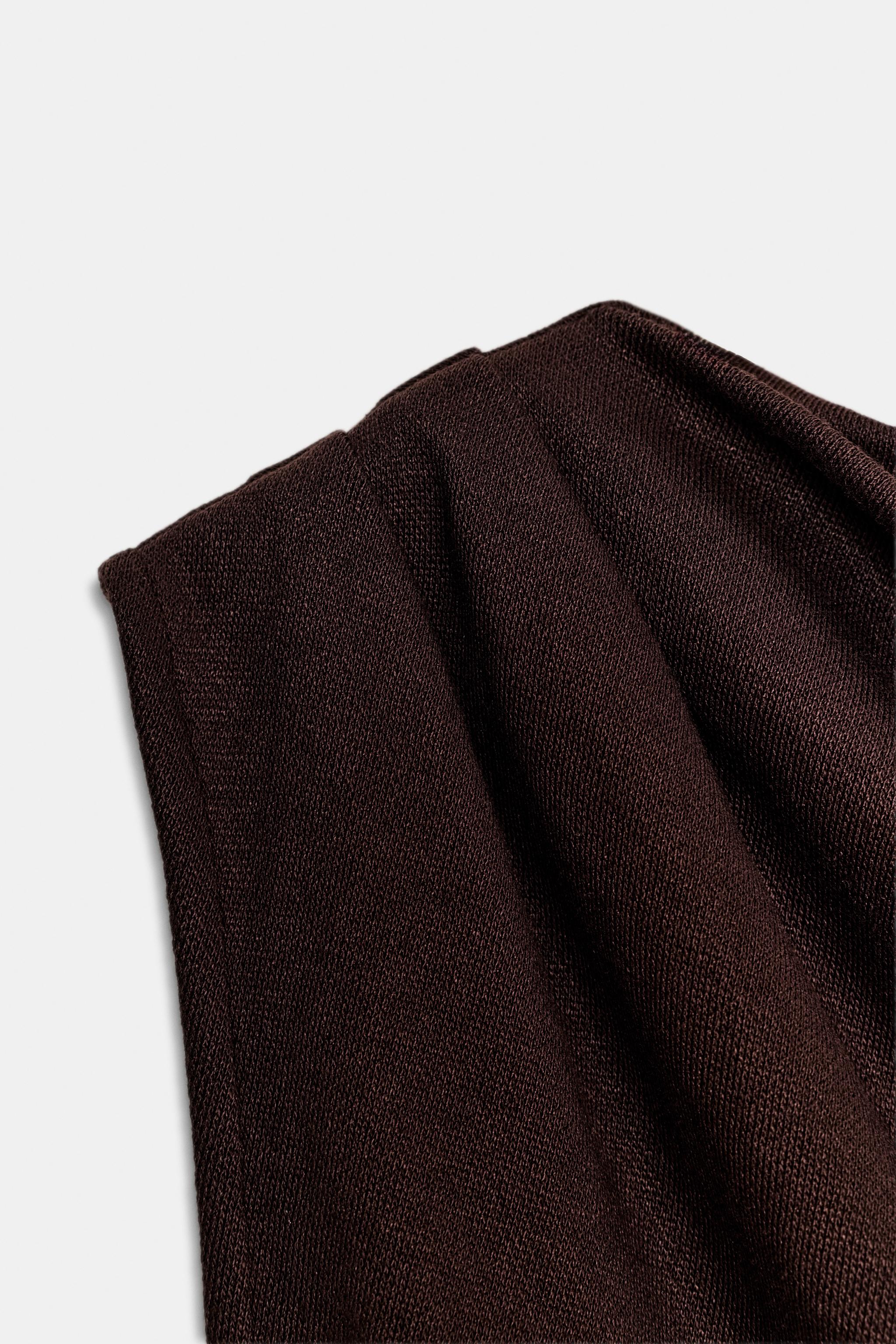 TOP ASYMÉTRIQUE EN MAILLE COUPÉE