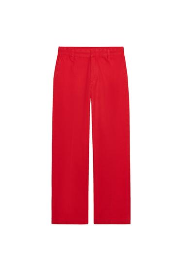 Front view of red trousers with side pockets and a waistband with belt loops.