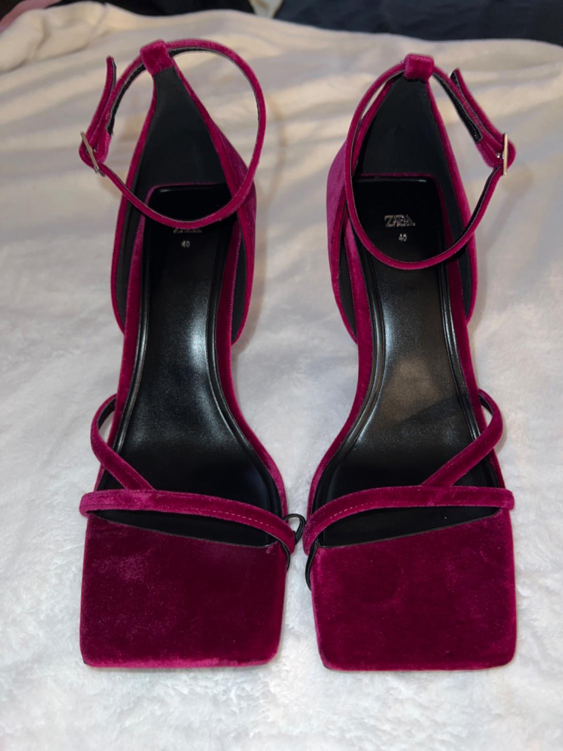 Front view of fuchsia heeled sandals with criss-cross straps and buckle fastening