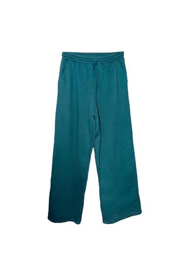 Teal wide-leg trousers with an elasticated waist and adjustable drawstring, displayed on a white background.