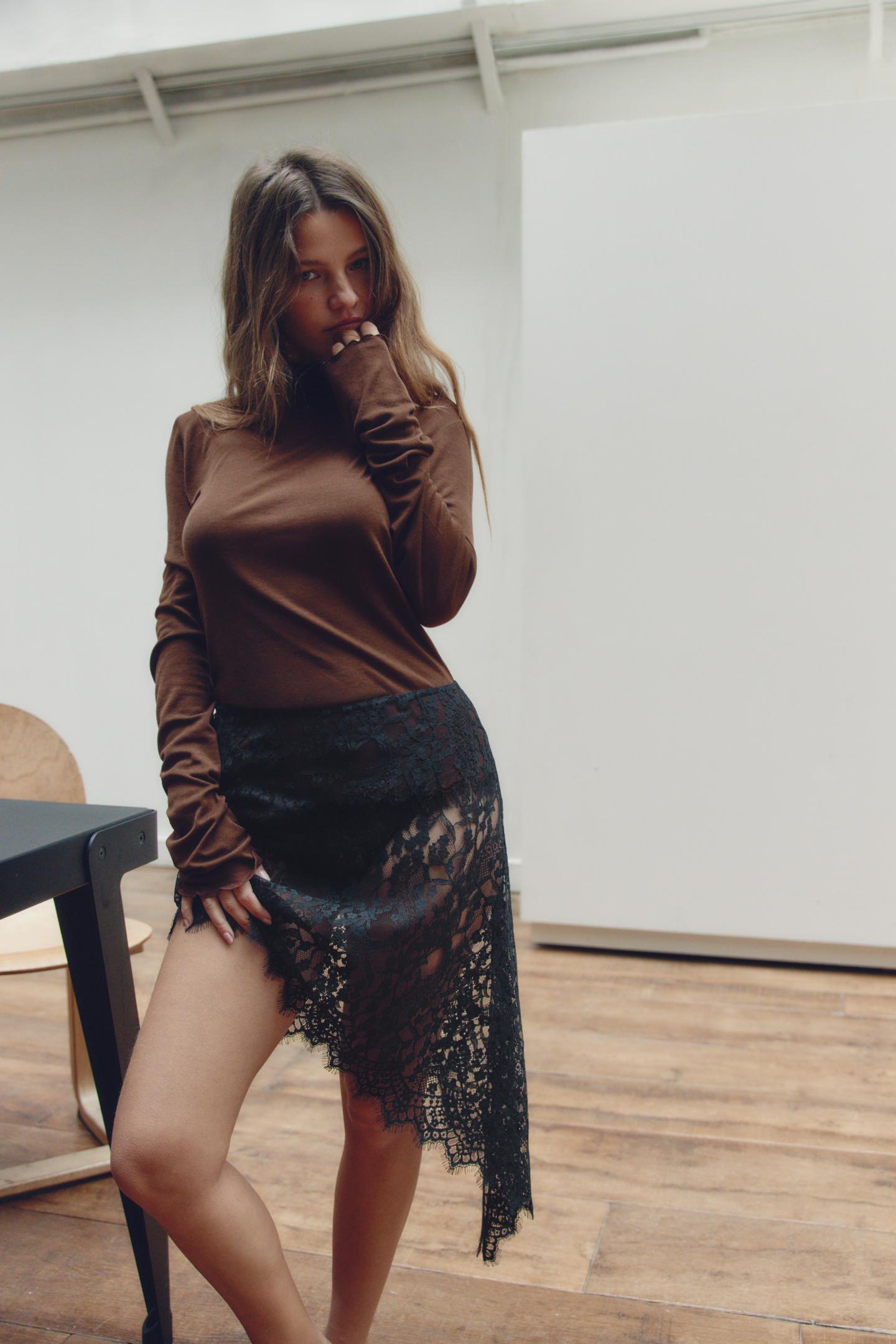Brown long-sleeve blouse and black asymmetrical semi-sheer lace midi skirt set.