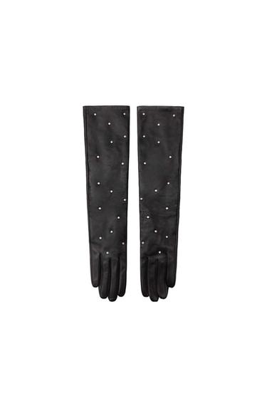 Front view of long black gloves with decorative silver studs.