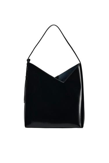 Glossy black shoulder bag with a geometric design, V-shaped top edge and slim strap, photographed against a white background.