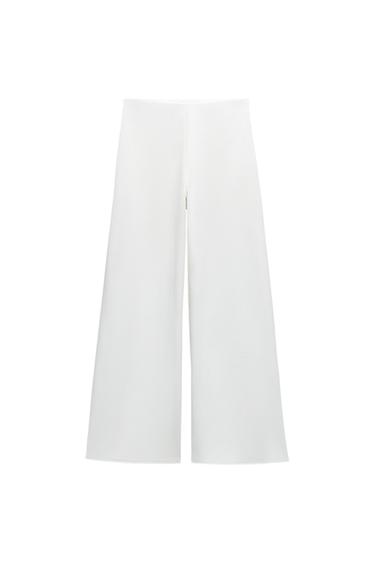 Front view of white wide-leg trousers.