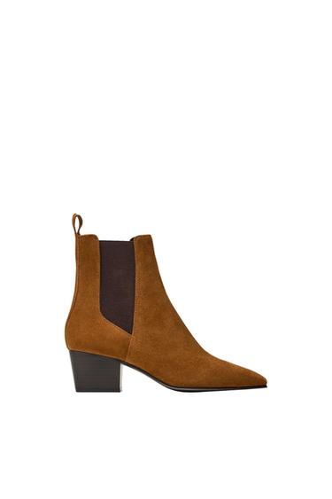 Low-heeled brown boot with a dark elastic panel and back pull tab, on a white background.
