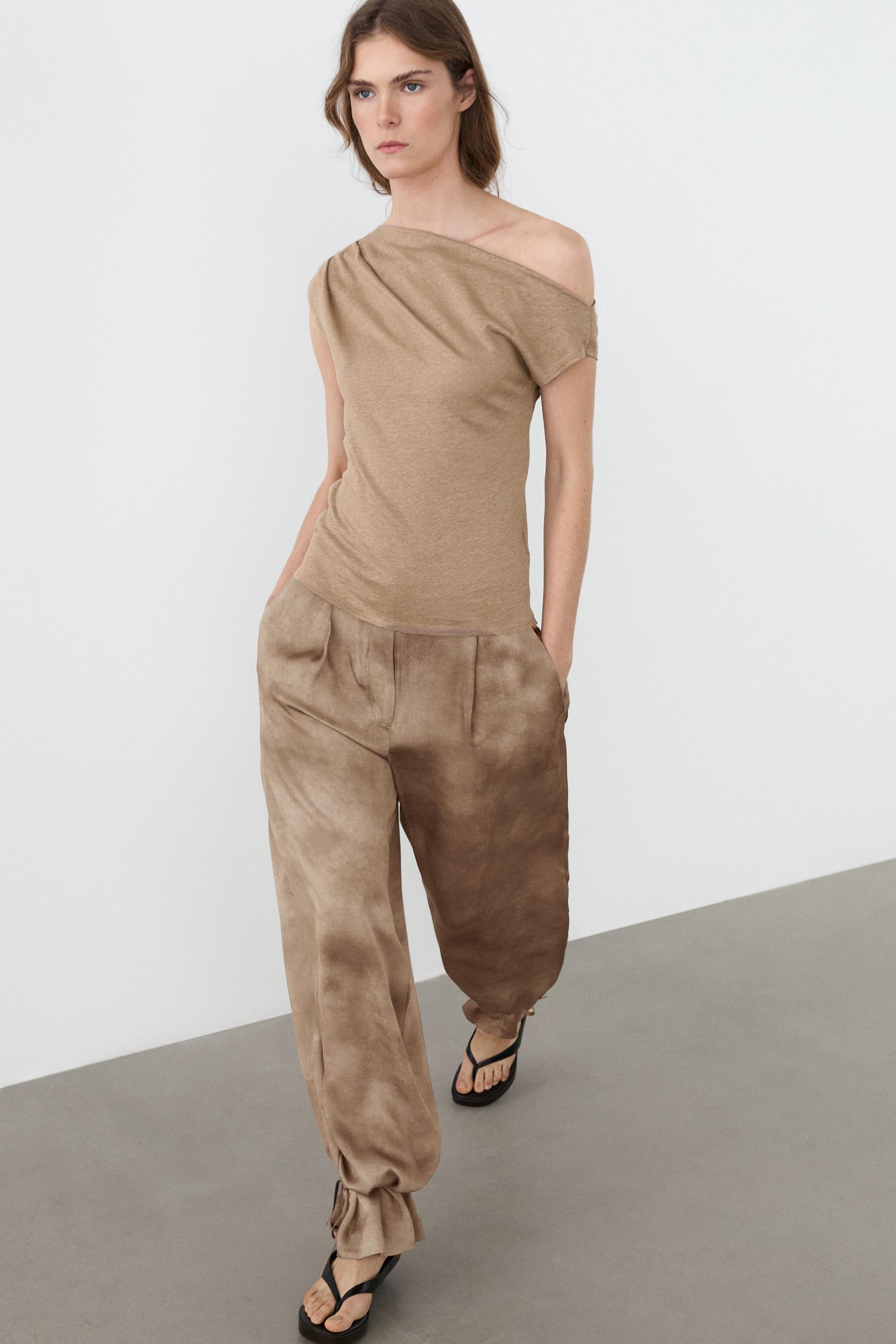 Flowing pants with tie-detail hem — Beige