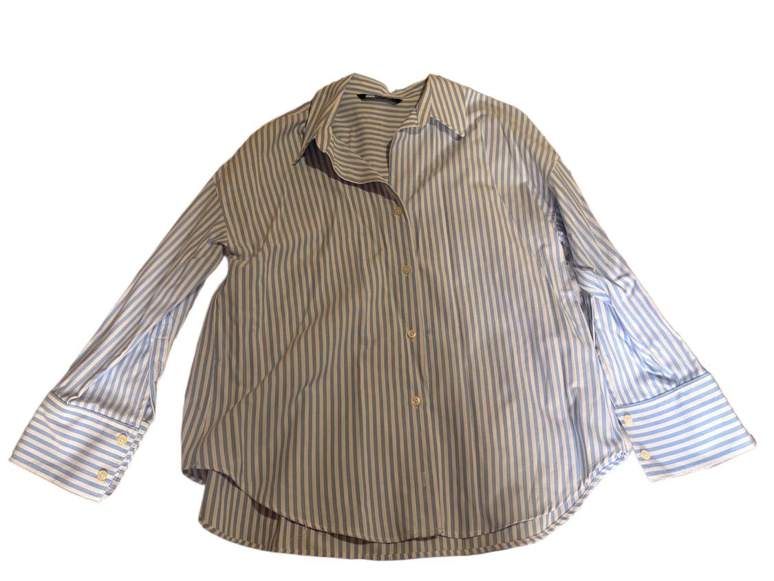 Blue and white vertical striped shirt with a classic collar and buttoned cuffs, on a white background.