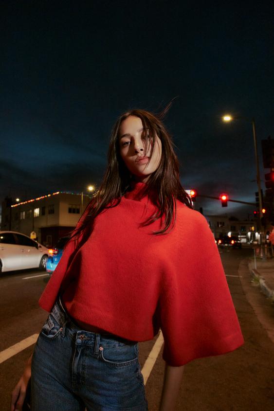 Sada �erven�ho pleten�ho svetru s rol�kem a �irok�mi ruk�vy, v kombinaci s modr�mi d��ny.