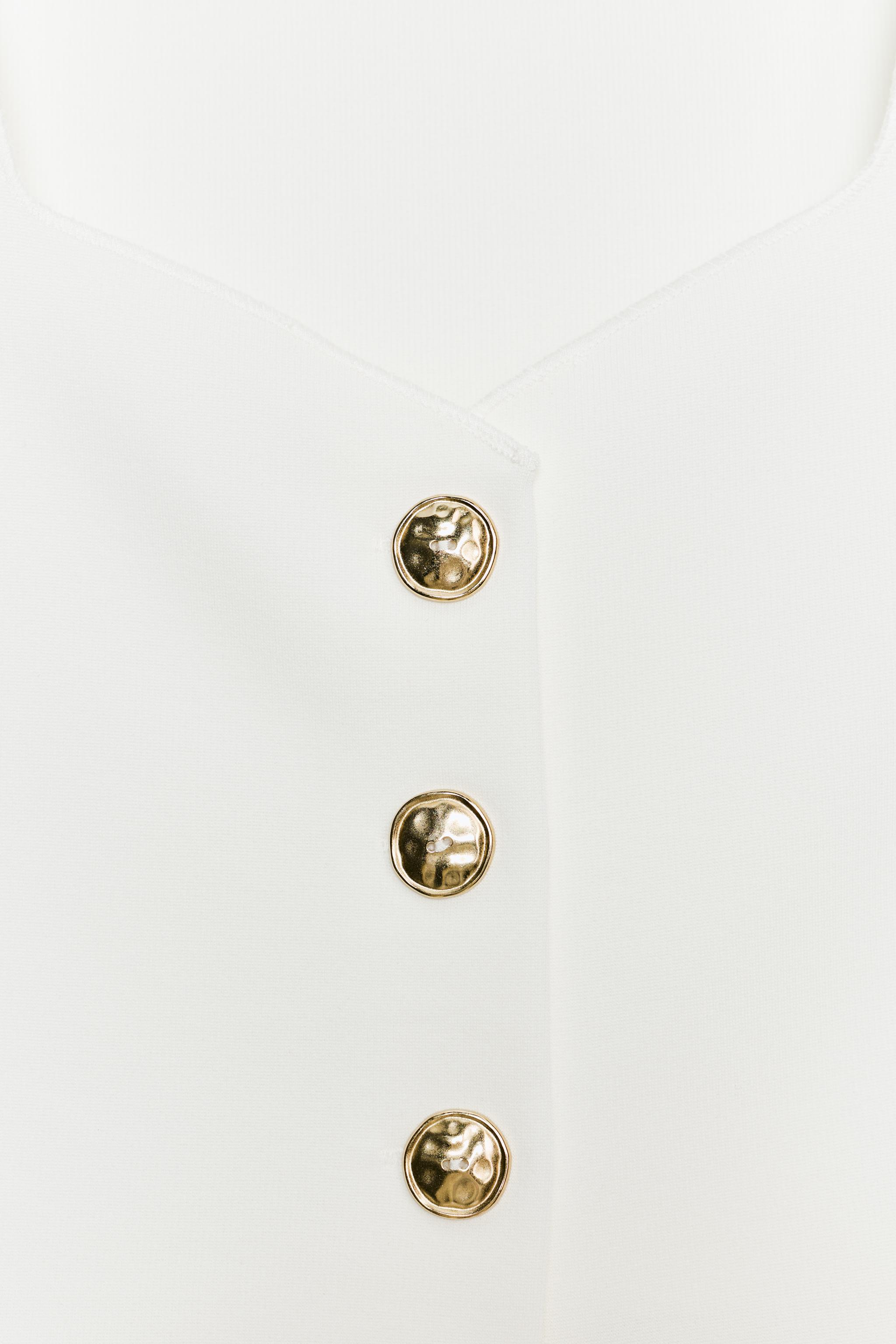 TOP PÉPLUM À BOUTONS