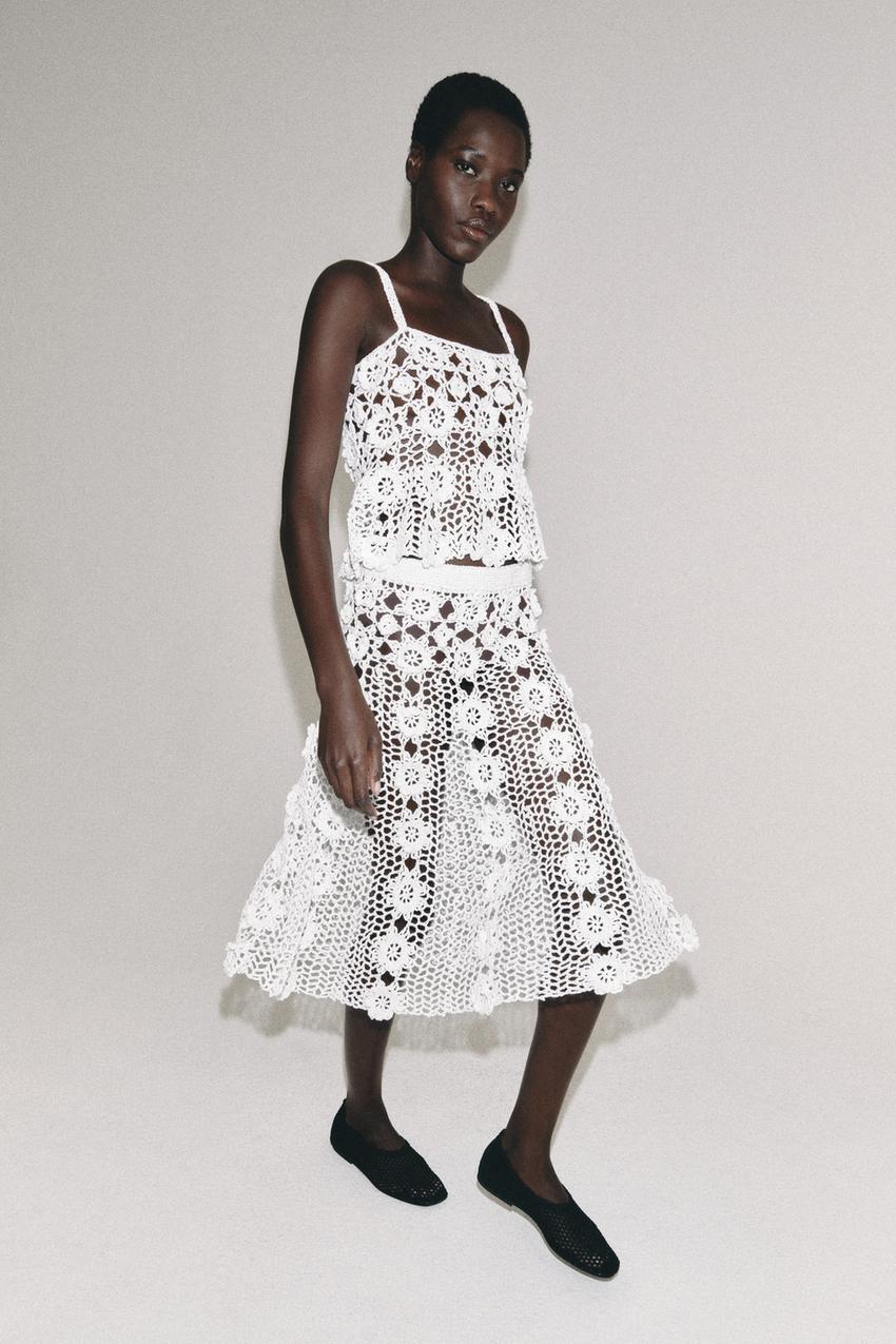White spaghetti strap crop top and matching skirt set with a cut-out floral fabric.