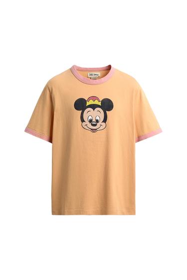Peach-coloured short-sleeved t-shirt with pink trim. Mickey Mouse print on the front. Text on inside label: ZARA Disney.