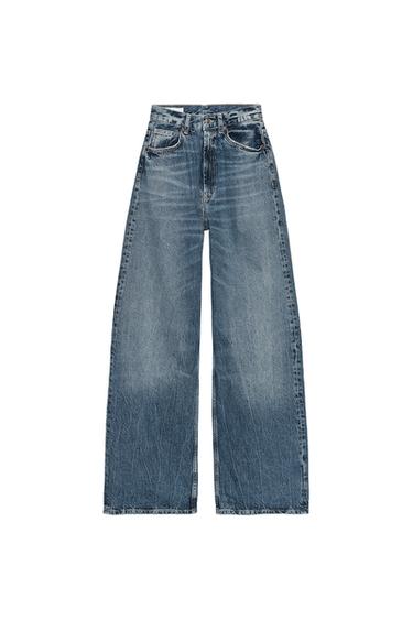 Front view of high-waisted, wide-leg indigo jeans with five pockets. Front zip fly and metal button closure.