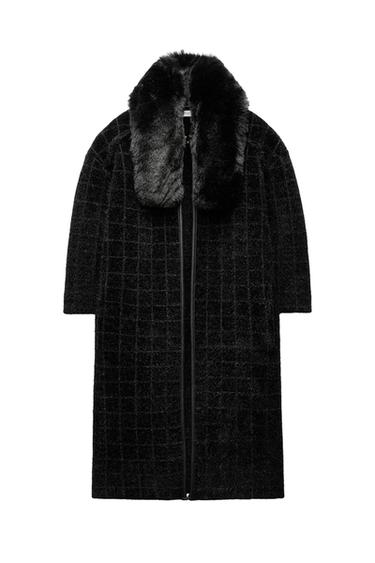 Front view of a black coat with a fur collar and check pattern.