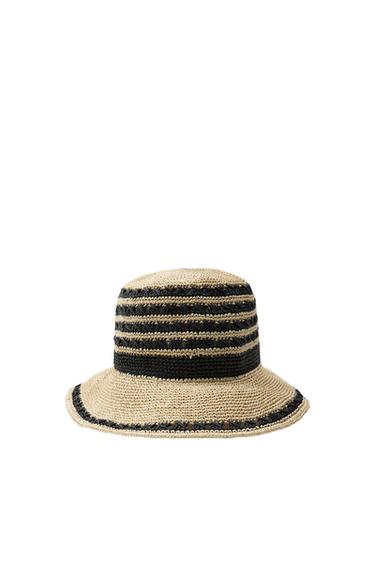 Front view of a beige knit hat with black stripes.