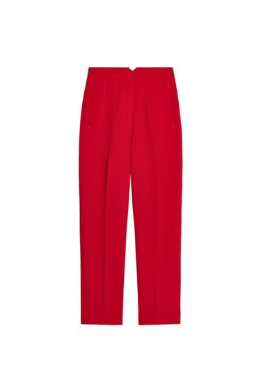 Front view of red trousers with side pockets.