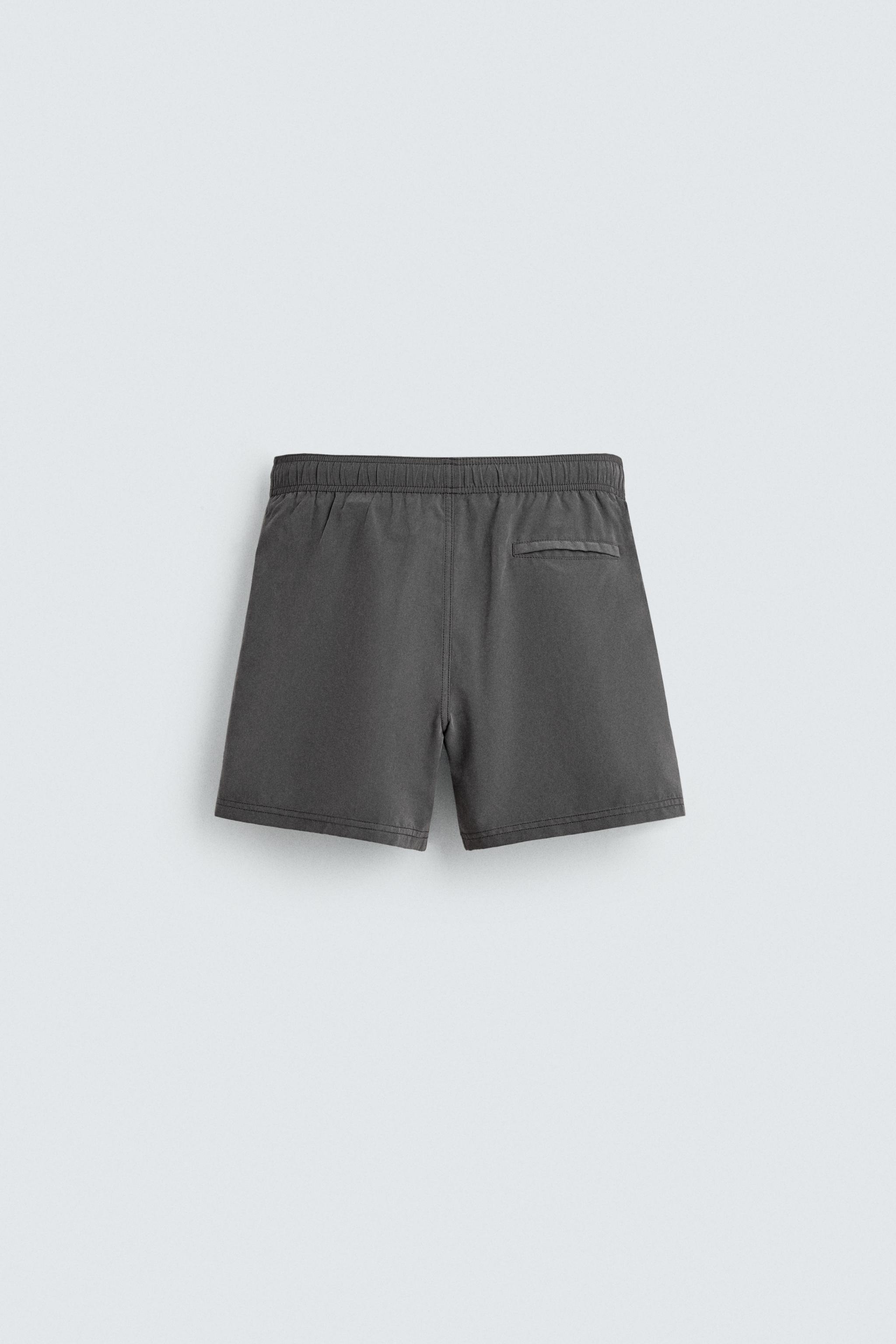 MAILLOT DE BAIN MI-LONG À ŒILLETS MÉTALLIQUES