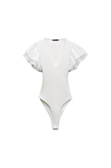 White ribbed bodysuit with a V-neck and short sleeves with pleated ruffles on a white background. ZARA label.