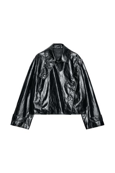 Front view of a black cropped jacket with sparkle, lapel collar, adjustable long sleeves, and front pockets. Fastens with concealed buttons.