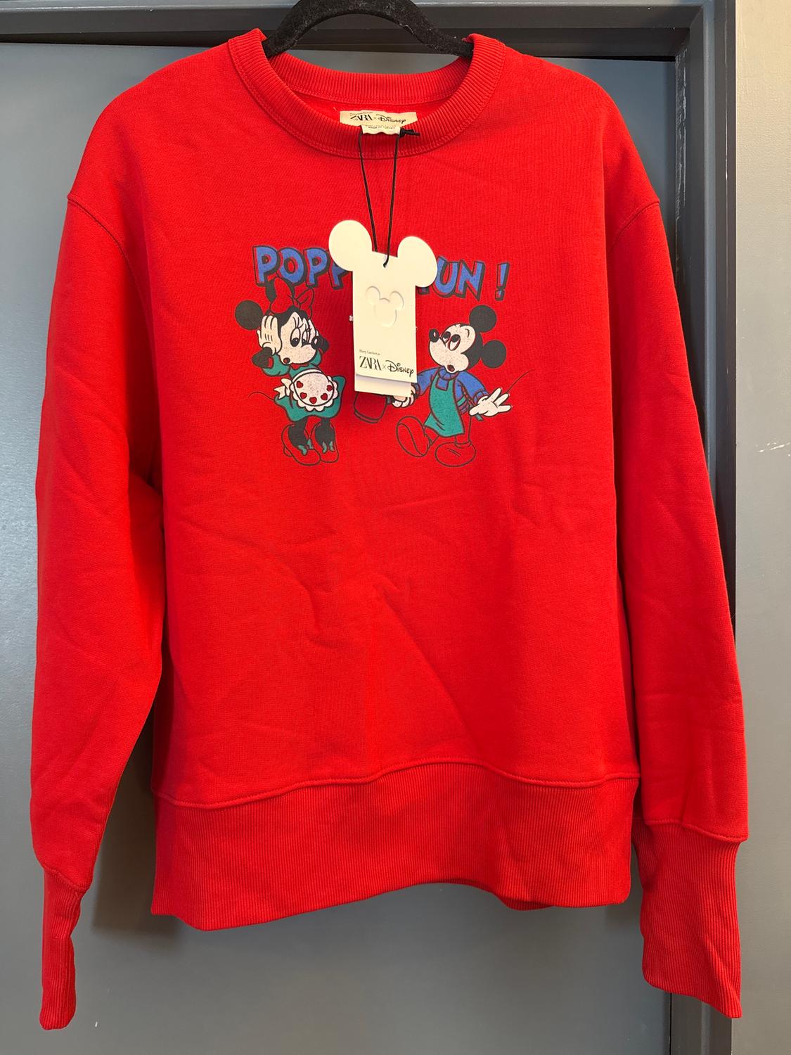 Red sweatshirt with animated character print and "POP FUN!" text. Mouse head-shaped swing tag.