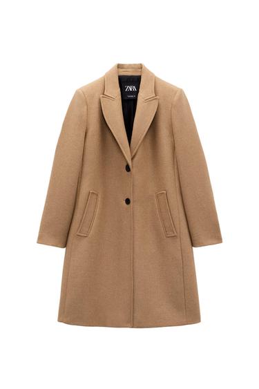 Camel wool coat with lapels and two black buttons. Slanted pockets and visible inner label with the text "ZARA".
