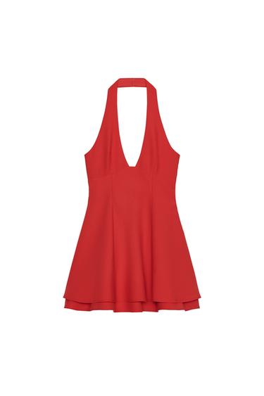 Front view of a short, sleeveless red dress with a halter neck and V-neckline, featuring a double layer and concealed side zip fastening.