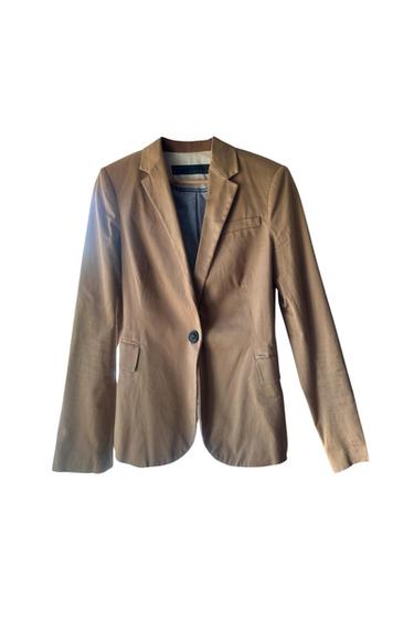 Brown, single-breasted jacket with classic lapels and front pockets, hanging against a white backdrop.