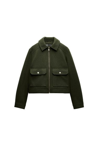 Front view of dark green jacket with zip and front flap pockets.
