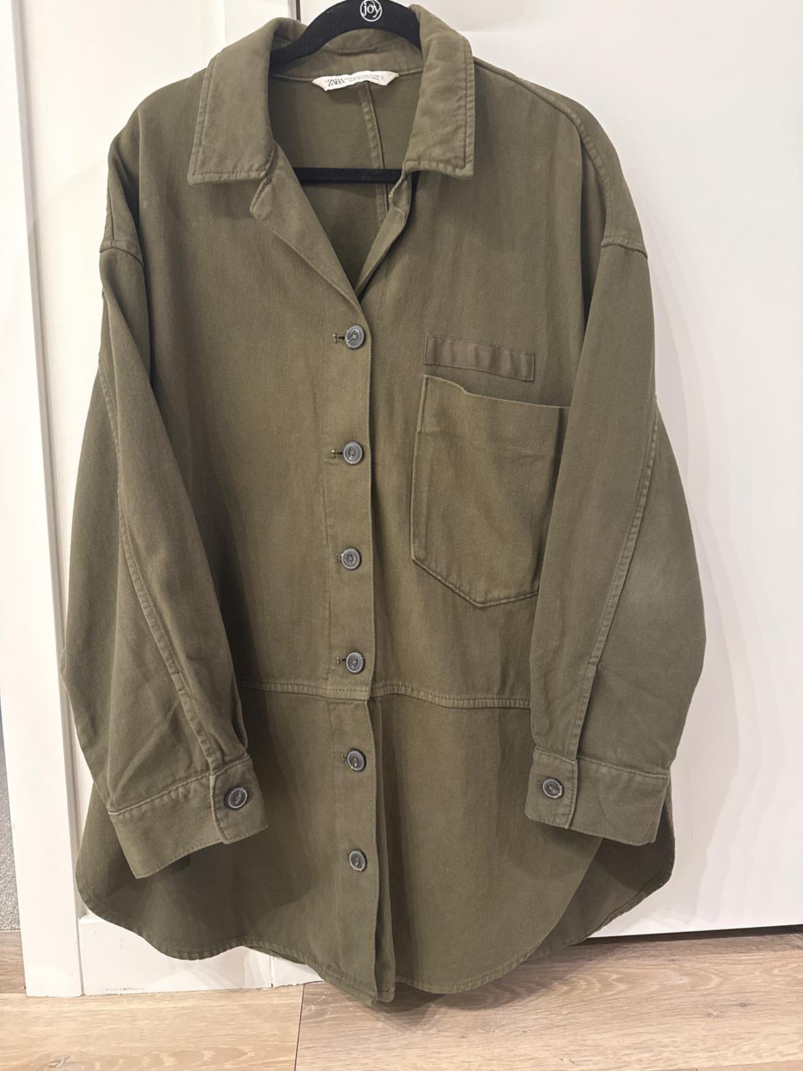 Front view of a green button-up shirt with a left front pocket.