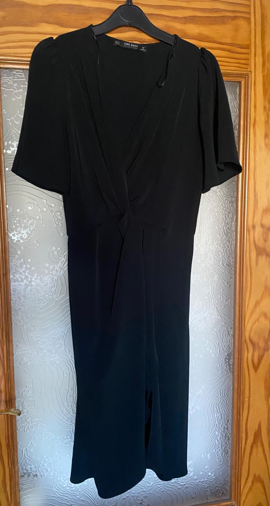 Front view of a black dress with a V-neck and short sleeves.