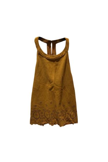 Mustard yellow sleeveless top, round neck, hem with floral die-cut details and scalloped edge on a white background.