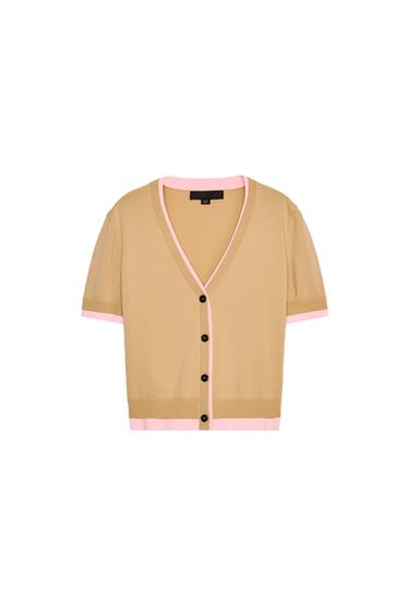 Front view of a beige cardigan with pink trim and black buttons