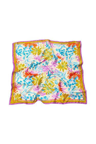 Square scarf with a floral print in shades of blue, green and orange on a light background, with a purple and mustard border, featuring soft folds.