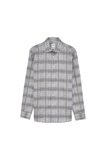 Checked shirt in grey and black tones with a classic collar and front buttons. Visible label on the neck with text "ZARA".