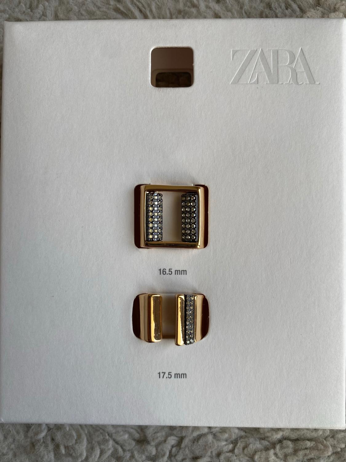 White card with two gold rings set with stones. Text: ZARA, 16.5 mm, 17.5 mm.