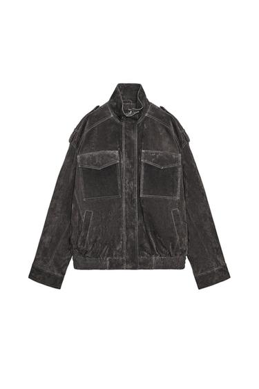 Front view of taupe brown jacket with stand-up collar, long sleeves, front flap pockets and zip fastening.