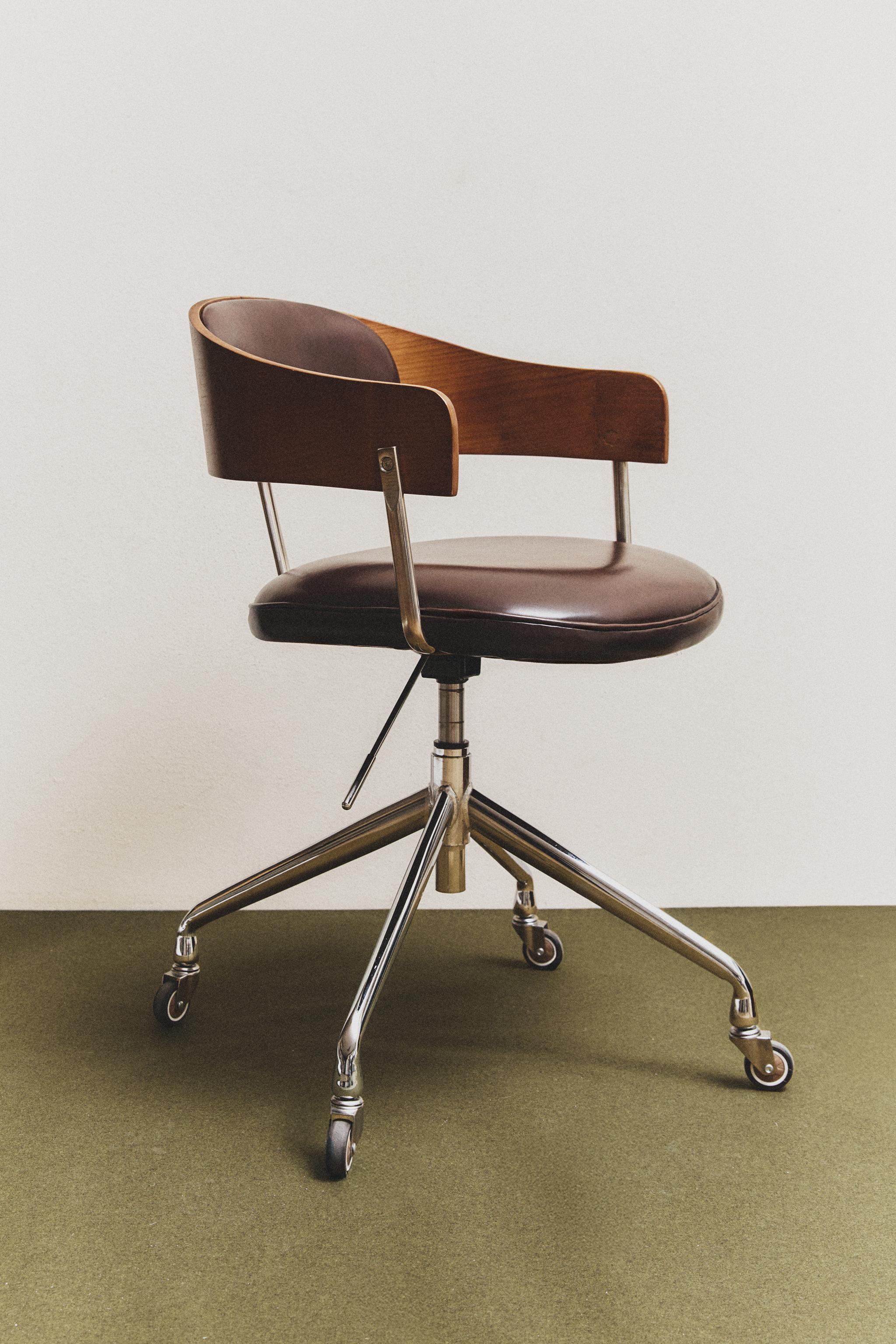 Full view of a vintage-style office chair with wooden backrest, leather seat, and metal base on casters