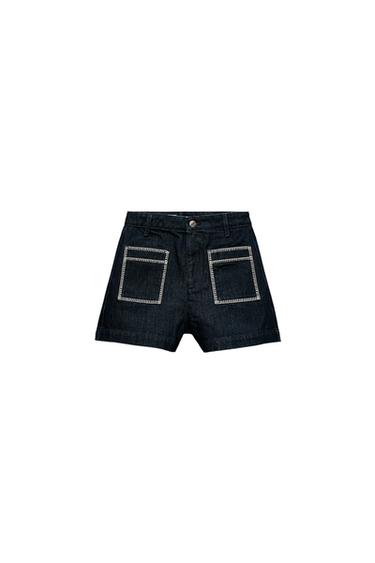 Front view of dark shorts with decorative square pockets and button waistband.