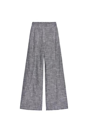 Front view of textured grey wide-leg trousers.