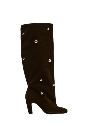 Side view of a brown high-heeled boot, decorated with silver studs.