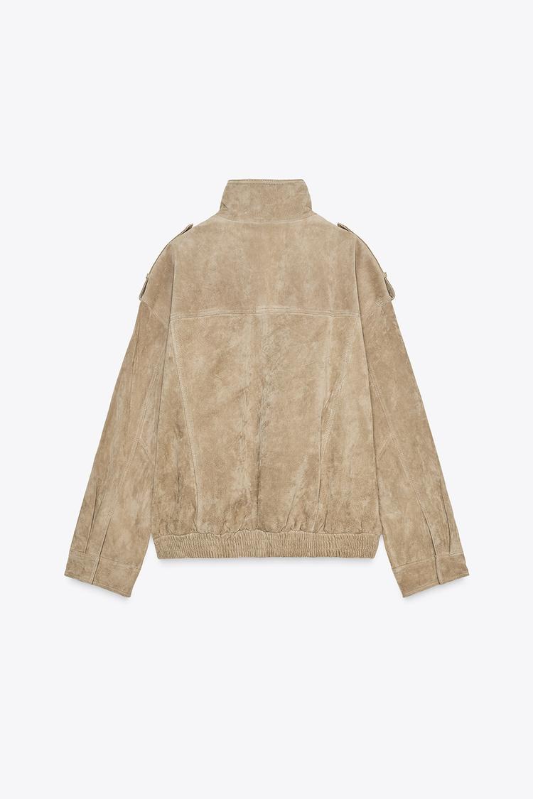 Back view of a charcoal-coloured cropped jacket with long sleeves and a notched lapel.
