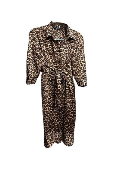 Animal print dress with a bow at the waist and three-quarter sleeves, on a white background.